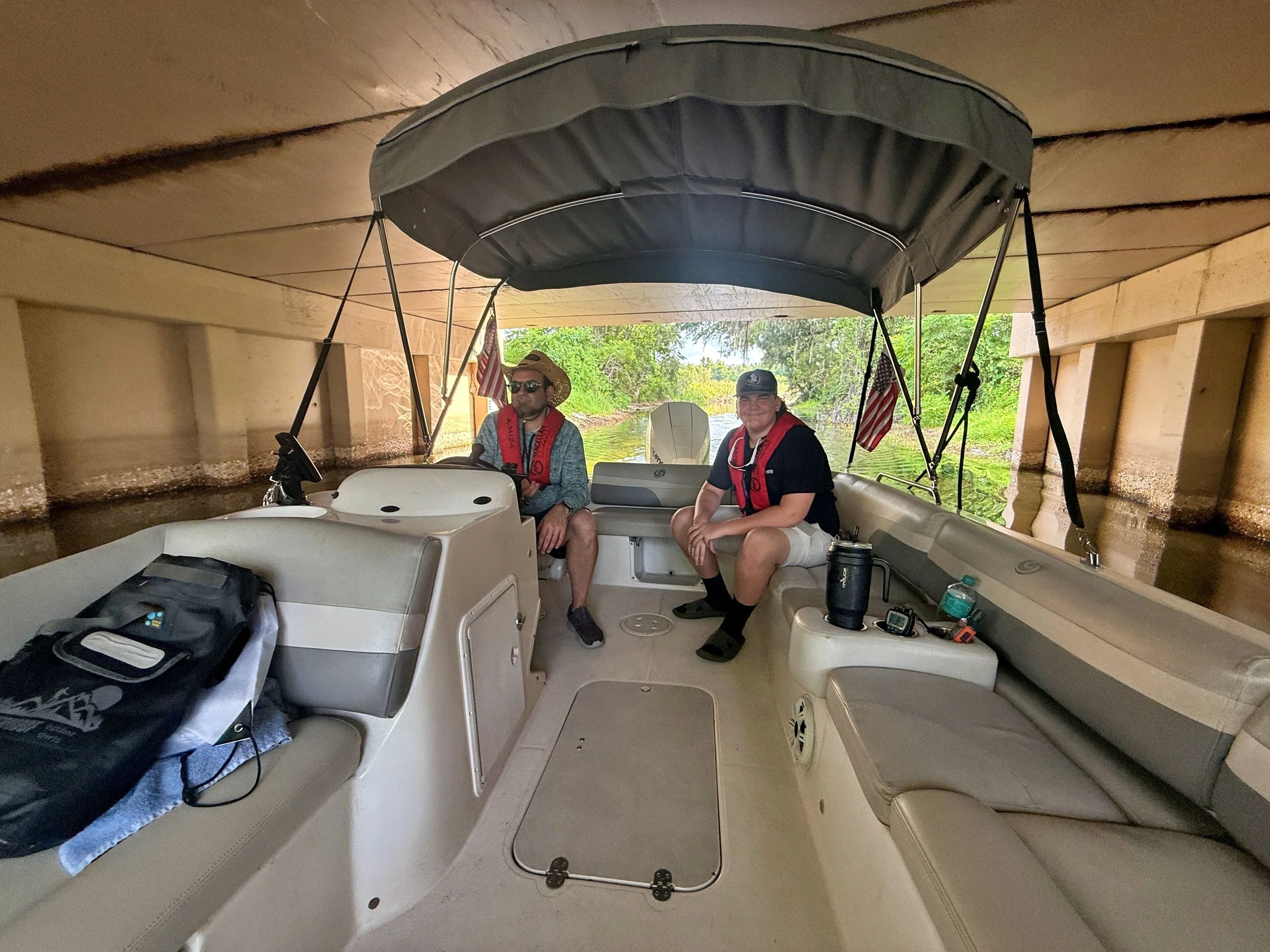 Two boaters wearing life jackets aboard CFBA’s Hurricane deck boat